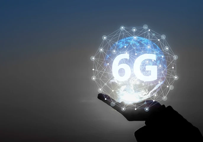 A hand holding up an animated ball signifying connectivity around the world with the word "6G" on it.