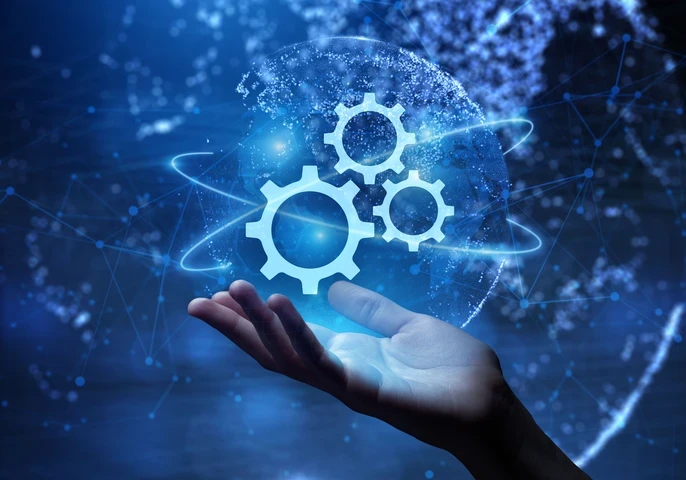 Hand holding up an animated logo of gears.