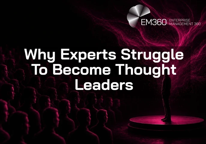 EM360Tech header graphic titled “Why Experts Struggle To Become Thought Leaders.” A lone speaker stands on a circular stage facing a large audience seated in darkness. Pink and magenta light swirls behind the speaker against a black background, creating a dramatic contrast. The EM360 Enterprise Management 360 logo appears in the top right corner.