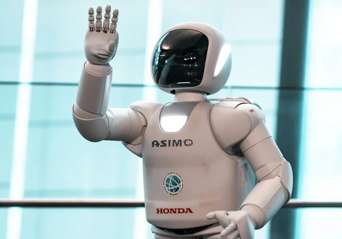A humanoid robot by Honda being showcased at an event.