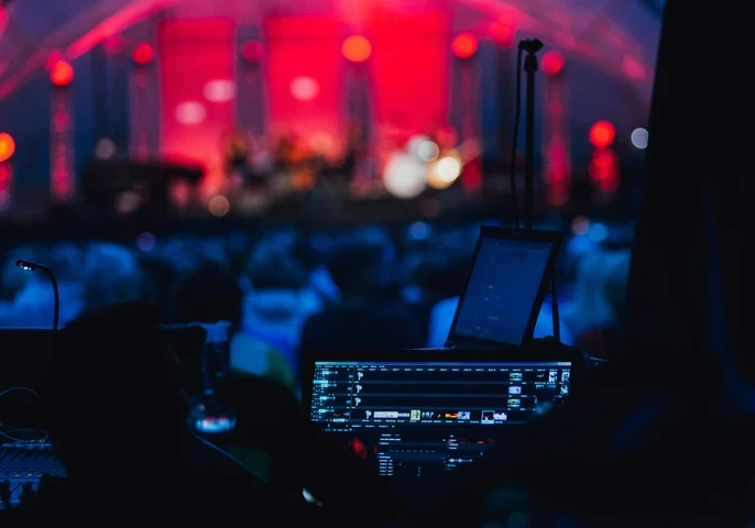 Sound board at a brightly lit corporate event.