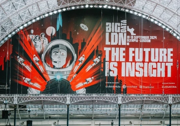 Wide interior view of Olympia London beneath its white arched glass roof, featuring a huge red, black and white Big Data LDN banner with an astronaut graphic and the text “BIG DATA LDN! THE FUTURE IS INSIGHT”, alongside the 18–19 September 2024 event dates and sponsor logos.