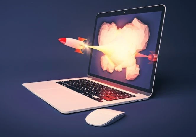 laptop showing a rocket flying out of the screen
