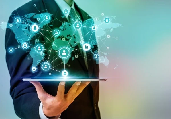 A person holding a tablet with a map of the world on it