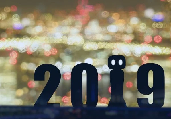The year 2019 shown in front of a glowing cityscape with the 1 being represented by a robot