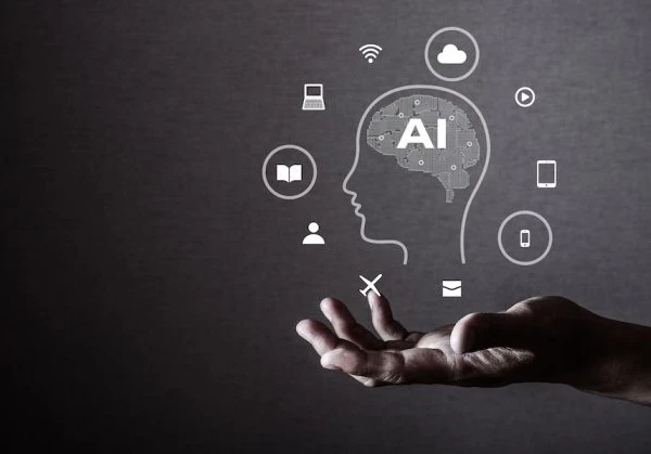 A hand with palm outstretched with a sketch of a head with a brain that reads AI, surrounded by digital symbols, including WiFi, tablets, email, laptops, showing skills required to use AI