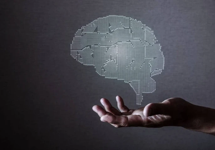 Decorative image of brain in computer chip styloating above hand