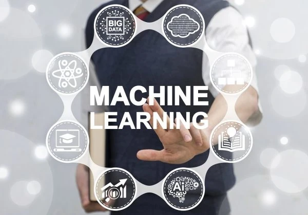 Man standing in front of a graphic depicting machine learning elements.