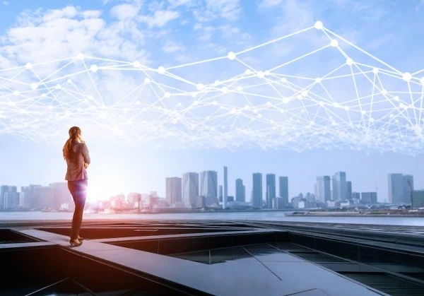 Person looking out across a river to a city skyline