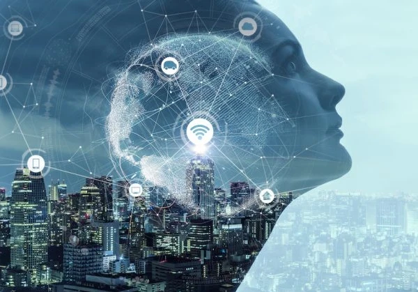 Graphic of a person's profile overlaid on a cityscape with connectivity logos (wifi, phone, tablet) dispersed over the face