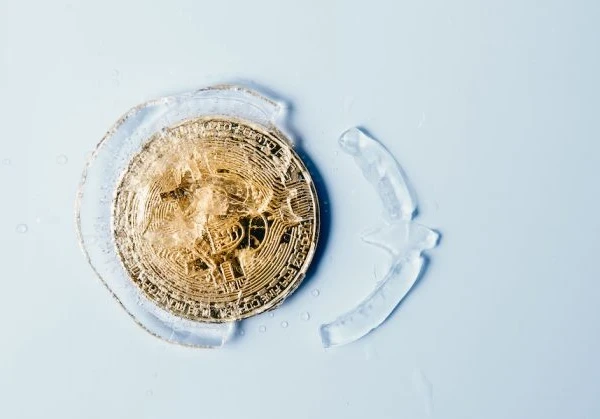bitcoin coin in gold frozen in ice
