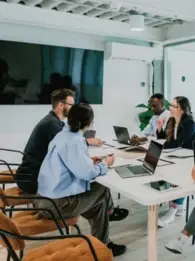 Five professionals working around a table. 