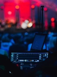 Sound board at a brightly lit corporate event.