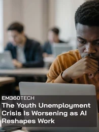 EM360Tech news graphic showing a young man looking thoughtfully at a laptop in a shared workspace, with other people working on laptops in the blurred background. Text reads: &ldquo;The Youth Unemployment Crisis Is Worsening as AI Reshapes Work.&rdquo; 