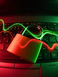 An image depicting a closed lock laying on a laptop keyboard with red and green swirls flowing across.