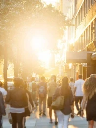 People walking on a busy street in a city