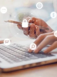 person working on a smartphone and laptop