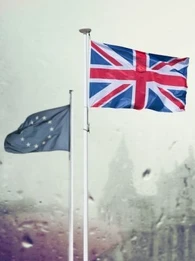 EU and Union Jack flags flying in front of St Paul's Cathedral in the rain