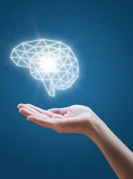 Someone holding a line drawing of a human brain in white