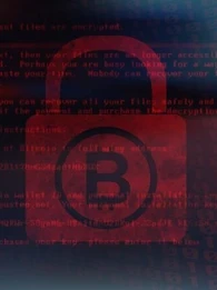 bitcoin logo on a padlock behind lines of code in red