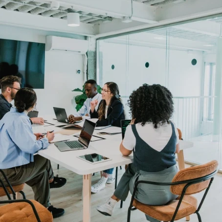 Five professionals working around a table. 