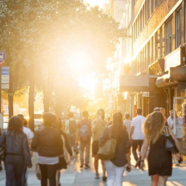 People walking on a busy street in a city