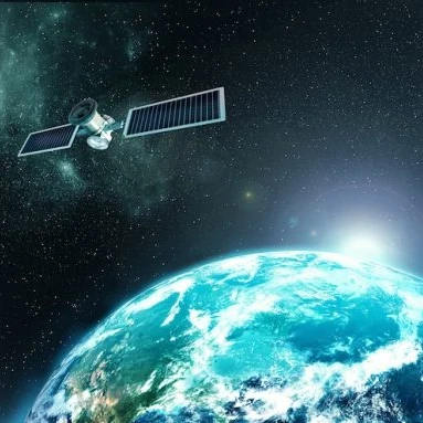 Image from space of a satellite floating above the Earth with the sun behind