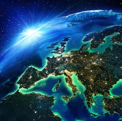 Image of the world with the rising sun in the background and the focus on Europe lighting up