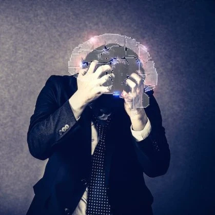 A business person in a suite holding his head in anguish